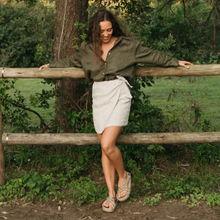 Load image into Gallery viewer, Woman leaning against a wooden fence in a natural setting
