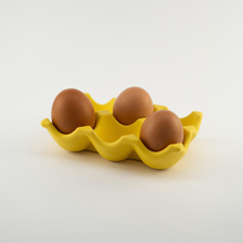 Load image into Gallery viewer, Yellow ceramic egg carton with three brown eggs on a white background
