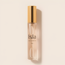 Load image into Gallery viewer, Isla perfume bottle with gold cap on a beige background
