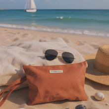 Load image into Gallery viewer, Beach scene with sunglasses, bag, and hat on sand, sailboat in distance.
