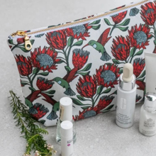 Load image into Gallery viewer, Protea-patterned pouch with skincare products on a light background
