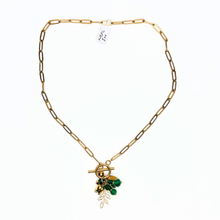 Load image into Gallery viewer, Gold necklace with green leaf charm on a white background
