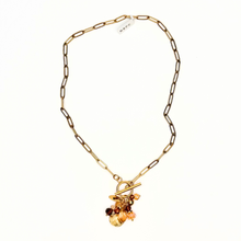 Load image into Gallery viewer, Gold necklace with a floral pendant on a white background

