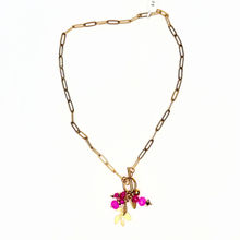 Load image into Gallery viewer, Gold chain necklace with pink charms on a white background
