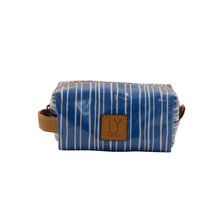 Load image into Gallery viewer, Blue striped toiletry bag with a brown leather strap on a white background
