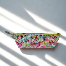 Load image into Gallery viewer, Floral patterned make-up bag on a light background
