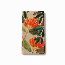 Load image into Gallery viewer, Floral patterned fabric napkin with orange flowers and green leaves on a beige background
