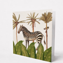 Load image into Gallery viewer, Greeting Card with a Zebra in a tropical setting with palm trees and leaves on a beige background
