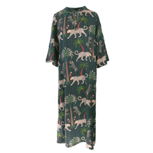 Load image into Gallery viewer, A dark green kaftan dress featuring an all-over print of leopards, palm trees, and birds, shown against a plain white background.

