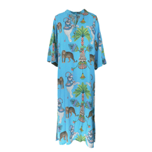 Load image into Gallery viewer, A light blue kaftan dress featuring a vibrant, all-over print of Egyptian-themed motifs including pharaohs, pyramids, palm trees, and animals, shown against a plain white background.
