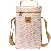 Load image into Gallery viewer, A cylindrical insulated bottle bag with a white background and a light brown speckled pattern, featuring a top handle, shoulder strap, and a brown eather IY logo patch on the front.
