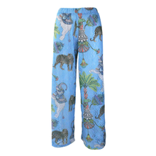 Load image into Gallery viewer, Rush Resort Light blue wide-leg pants featuring an all-over print of elephants, palm trees, and decorative patterns in green, gray, and red.
