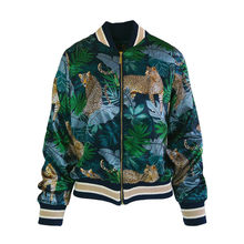 Load image into Gallery viewer, A zip-up bomber jacket featuring a tropical print of leopards and palm leaves in shades of green, navy, and gold, with cream and navy striped ribbed collar, cuffs, and hem.
