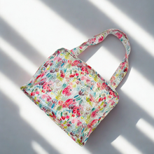 Load image into Gallery viewer, Floral patterned cosmetic bag on a white background
