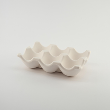 Load image into Gallery viewer, White ceramic egg tray on a light gray background
