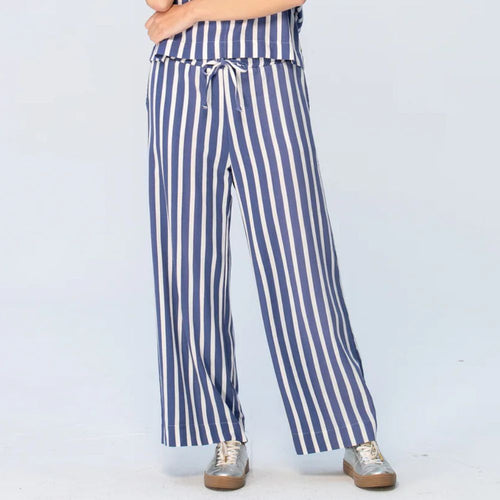 Blue and white striped pants worn by a person on a light blue background