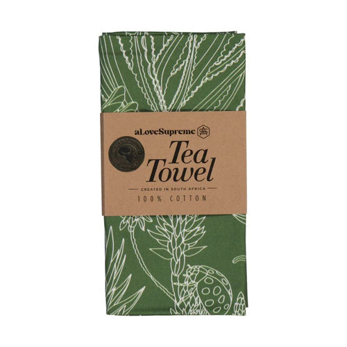 Green tea towel with botanical pattern and brown label on a white background