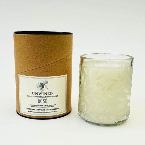 Unwined Rose candle in a glass container with packaging on a white background