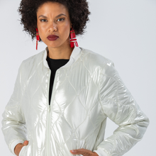 Load image into Gallery viewer, Woman wearing a Signature by Des shiny white puffer jacket with red earrings 
