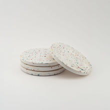 Load image into Gallery viewer, Set of four round speckled coasters on a light gray background
